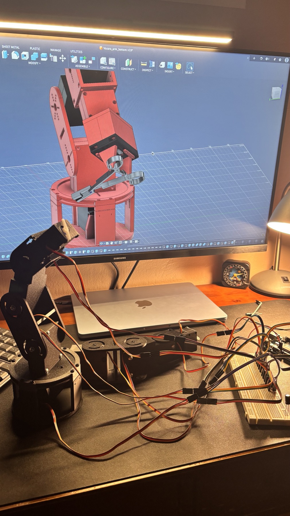 Workspace with CAD on monitor and physical arm