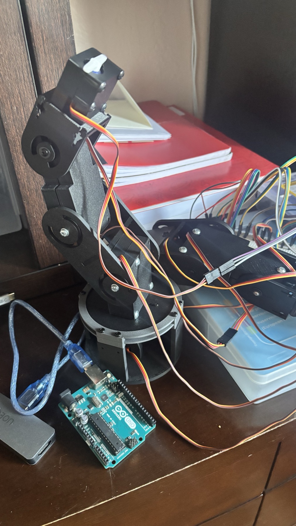 Detail of the 6-DOF arm with paired shoulder servos and the rack-and-pinion gripper